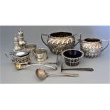 A quantity of silver to include cream jug and twin handled sugar basin with wrythen and repousse