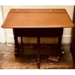 A Victorian mahogany Sutherland table, curved edge dropleaves, raised on turned supports on white