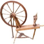 A 20th Century pine spinning wheel.