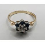 A 9ct gold diamond and sapphire cluster ring. Size N. Gross weight approximately 1.6 grams.