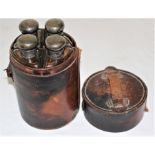 An Art Deco circular travelling spirit flask with four quadrant glass flasks with silver covers,