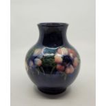 A William Moorcroft baluster Anenome pattern vase, with blue ground, impressed and painted marks,