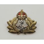 Military Interest: A 14ct. gold and red enamel Royal Navy Badge, width 23mm. (gross weight 4.1g)