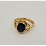 A precious yellow metal and sapphire ring, having mixed oval cut sapphire in rub over setting to