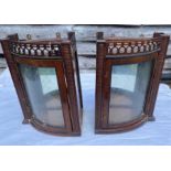 A pair of early 20th cent bow fronted wall mounted cabinets