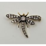 An 18ct. gold and diamond "dragonfly" brooch, bezel set single round cut diamond to centre and