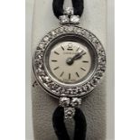 An 18ct. white gold Omega ladies' cocktail watch, having signed circular dial with baton hour