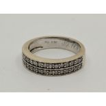 An 18ct. white gold two row half eternity ring, each row set seventeen round cut diamonds (ETDW 0.50