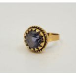 A precious yellow metal and light blue stone dress ring, claw set mixed round cut light blue