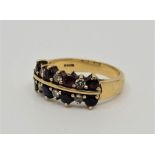 An 18ct. gold, diamond, sapphire and ruby two row half-hoop style ring, set four mixed round cut