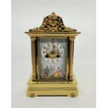 A late 19th century/early 20th century French brass mantle clock, gong strike, with hand painted