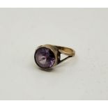 A 9ct. gold and sapphire ring, having mixed round cut sapphire in rub over setting to centre (