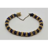 A gilt metal and lapis lazuli bead bracelet, c.1970's. (gross weight 37.1g) Condition note: in