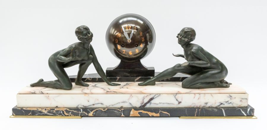A large 1930's Art Deco mantle clock with globe face and lady detail to either side