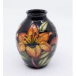 Moorcroft Pottery: A "Tigris Lily" patterned vase signed by Hugh Edwards, marked to underneath, in