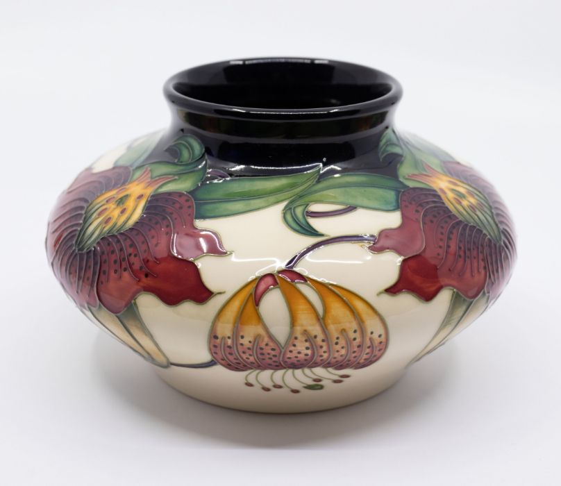 Moorcroft Pottery: An "Annalily" patterned vase, dated 1998, signed to underneath.  Approx. 11.5cm