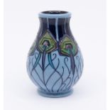 Moorcroft Pottery: A "Peacock Parade" patterned small vase, marks to underneath. Approx. 10cm high x