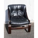 A Danish Kroken black leather and stained beech lounge chair after Ake Fribytter. Approx 81cm high x