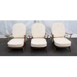 Ercol: Three mid 20th century easy arm chairs with fabric cushions. 2/3 have original hanging