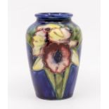 Moorcroft Pottery: A small "Orchid" patterned vase, 1928-1949, marked to underneath.  Approx. 9cm
