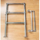 An Art Deco Chrome free standing towel rail with three rails and on two hexagonal feet with