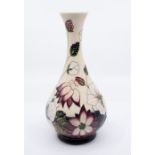 Moorcroft Pottery: A "Bramble" pattern, on cream background vase, dated 2010 and marked to base.