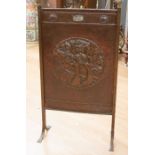 An Arts and Crafts hand made copper fire screen with brass columns and feet to each side, and with