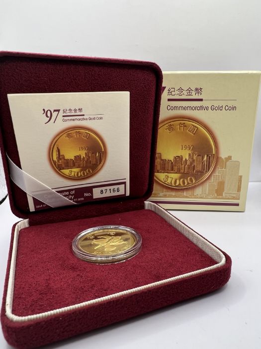 A 1997 Commemorative Hong Kong gold $1000 proof coin. Weight 15.976 grams. Paperwork detailling