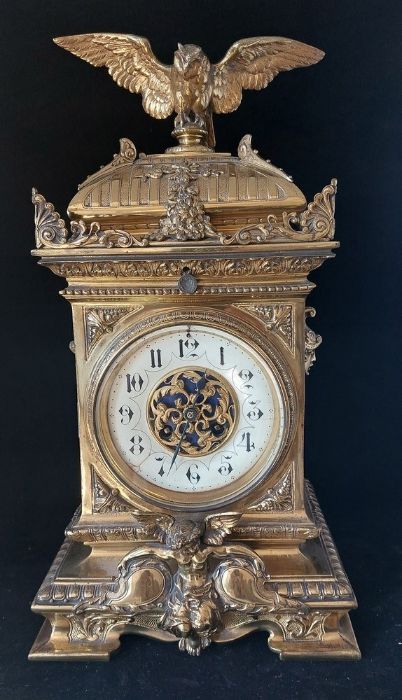 A French gilt brass mantel clock, late 19th, the enamel dial with Arabic numerals, the architectural