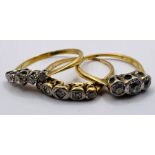 A set of three early 20th century diamond set rings. One a three stone diamond ring, size K;  a five