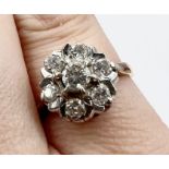 A raised diamond cluster ring in 18ct yellow gold. Estimated total diamond weight 0.50cts. Size L1/