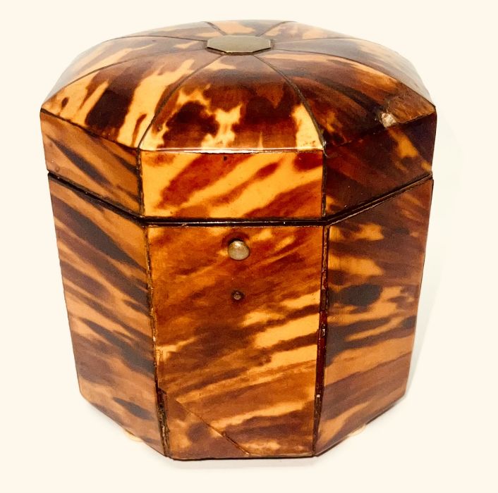 A Regency tortoiseshell tea caddy, circa 1810, in an octagonal shape with dome hinged lid, enclosing