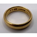 A 22ct gold band ring. Approximate weight  8.1 grams. Size N.