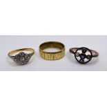 Three yellow metal rings. Comprising a seed pearl and amethyst round panel ring, stamped "15ct",
