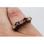A ruby and diamond five stone ring in yellow metal, stamped 14k. Approximate gross weight 3.2