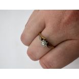 A yellow metal solitaire ring,circa early 20th century. Round brilliant cut diamond, estimated