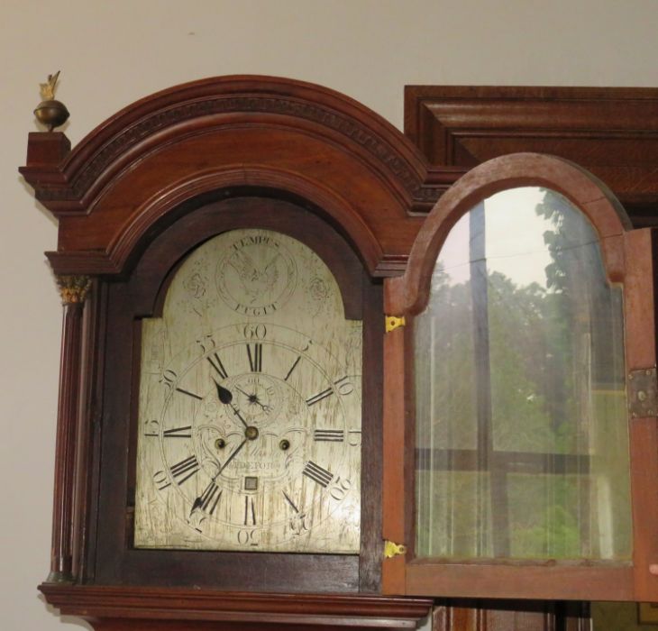 A George III mahogany longcase clock, the hood with arched top flanked by reeded brass capped