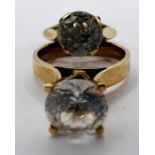 Two unmarked yellow metal rings, one set with cubic zirconia (size M, gross weight approximately 3.3
