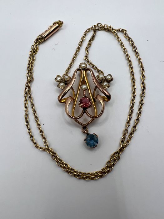 An Edwardian Lavaliere necklace, set with seed pearls, pink tourmaline and sapphire. Stamped 9ct.