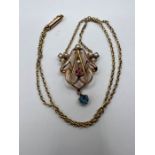 An Edwardian Lavaliere necklace, set with seed pearls, pink tourmaline and sapphire. Stamped 9ct.