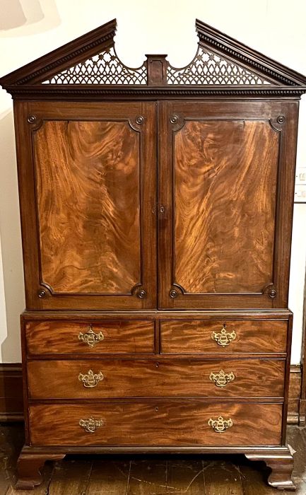 A George III mahogany linen press, in the style of Thomas  Chippendale, circa 1770, broken