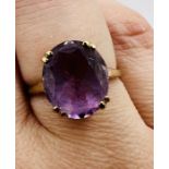 A 9ct gold amethyst cocktail ring. The amethyst is a mixed cut oval, measuring approximately 12mm