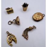 A selection of 9ct and yellow metal jewellery. Comprising a 9ct locket, 9ct horseshoe charm; a 9ct