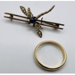 A dragonfly bar brooch, set with sapphire and seed pearls and stamped 9ct. Along with a "14k"