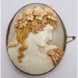 A shell cameo brooch depicting Dionysius in high relief. Marked 9ct to the reverse. Please note