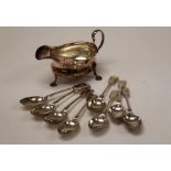 A small collection of silver plate. Featuring a large sauce boat, with hoofed feet, scallop rim