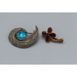 Two brooches, a 9ct gold 1970's garnet set flower brooch, weight approximately 3.8gm plus a sterling