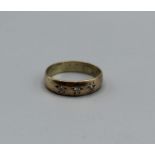 A 9ct gold band ring set with three Gypsy set diamond, size R, weight approximately 3.1gm