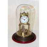 An early 20th German brass anniversary clock, with simulated ivory Arabic dial, on a stepped