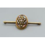 A diamond and pearl set bar brooch. The central raised oval panel is set with a central old mine cut